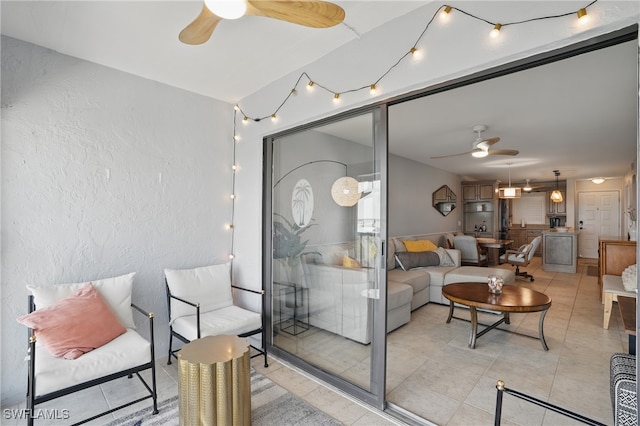 6891 Estero Blvd Unit 362, Fort Myers Beach, FL 33931 - living room featuring ceiling fan, a textured wall, and light tile patterned flooring