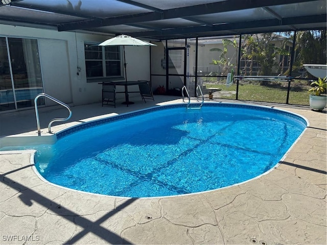 outdoor pool featuring a lanai and a patio area