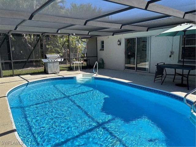 outdoor pool with a lanai and a patio