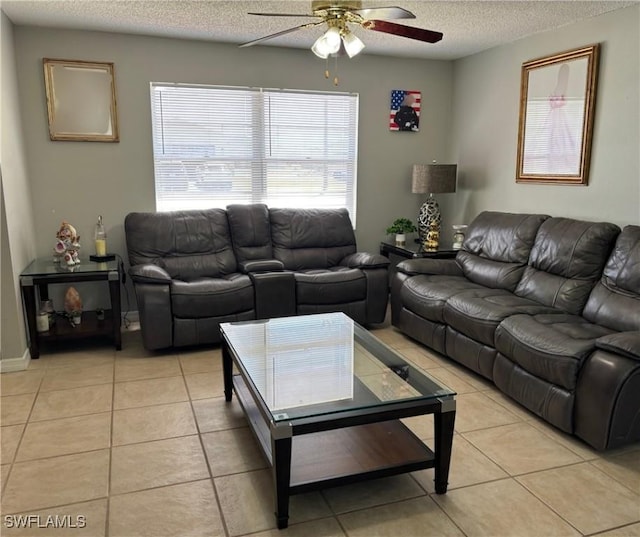 living area with light tile patterned floors, a textured ceiling, and a ceiling fan