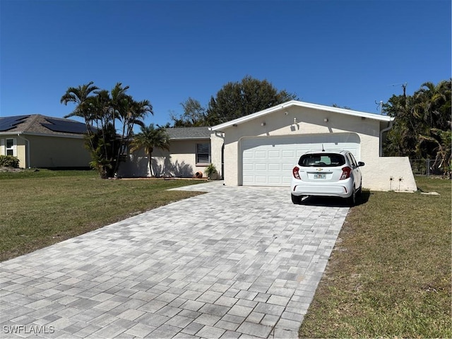 ranch-style home featuring a garage, decorative driveway, a front lawn, and stucco siding