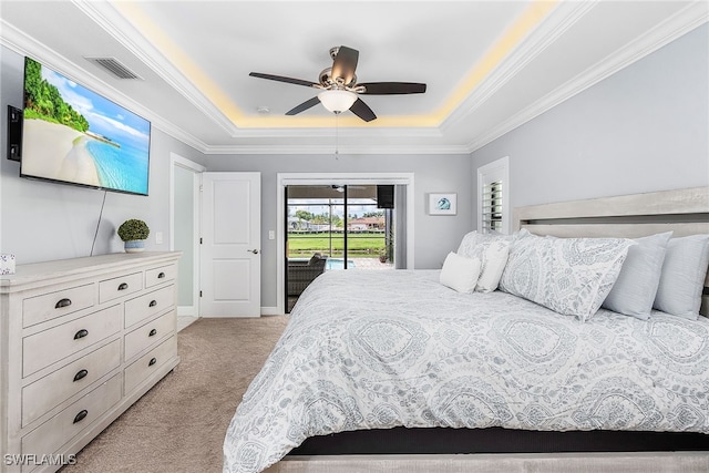 1702 SE 1st Ter, Cape Coral, FL 33990 - bedroom with light colored carpet, visible vents, access to exterior, a tray ceiling, and crown molding