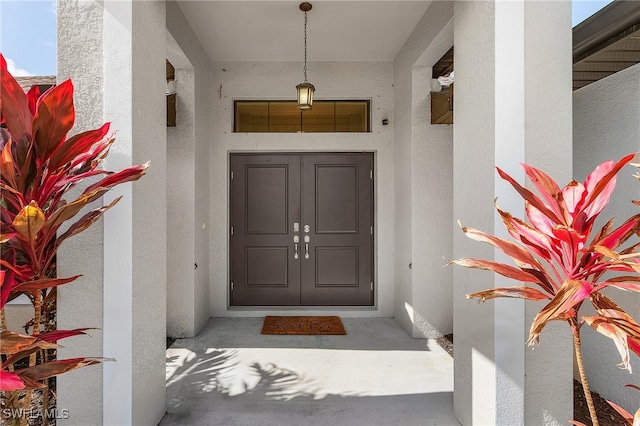 doorway to property with stucco siding