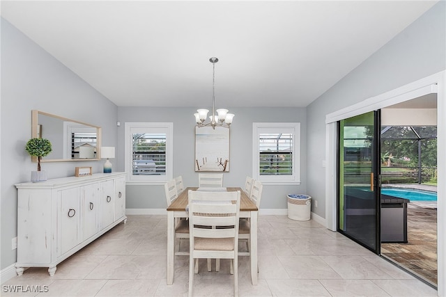 1702 SE 1st Ter, Cape Coral, FL 33990 - dining space with a chandelier, a wealth of natural light, vaulted ceiling, and baseboards