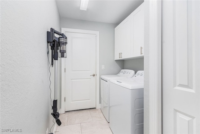 1702 SE 1st Ter, Cape Coral, FL 33990 - laundry area featuring cabinet space, washing machine and dryer, and light tile patterned floors