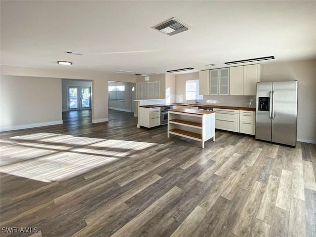 kitchen featuring visible vents, white cabinets, wood finished floors, stainless steel appliances, and french doors