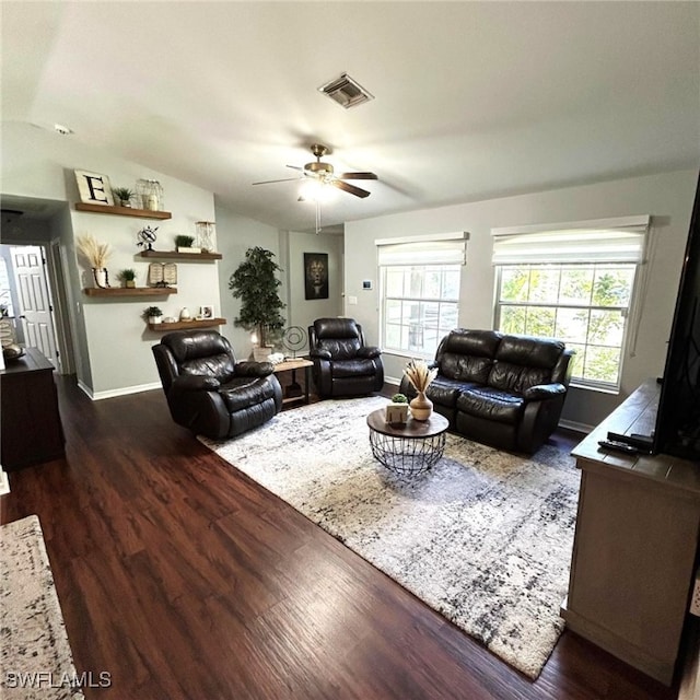 living room featuring a wealth of natural light, visible vents, lofted ceiling, and wood finished floors