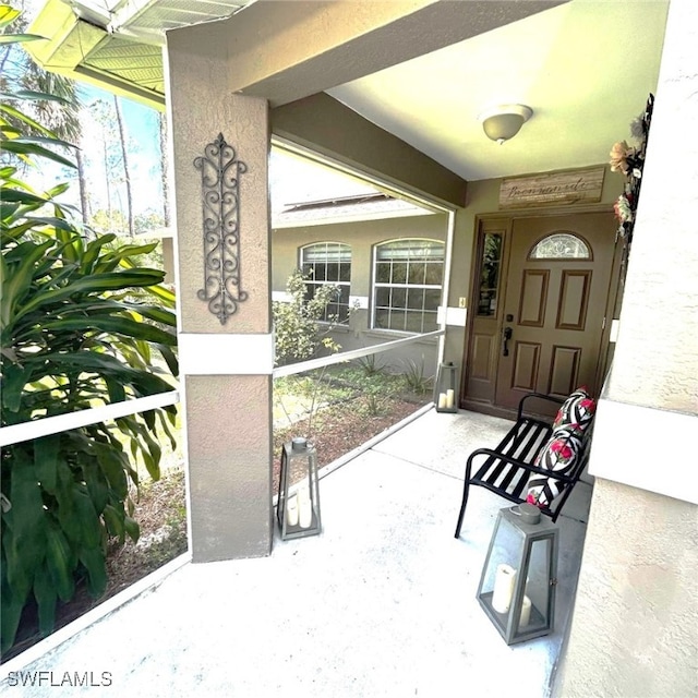 property entrance featuring stucco siding