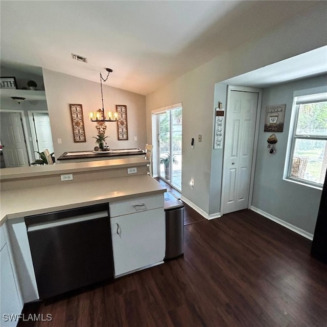 kitchen with lofted ceiling, stainless steel dishwasher, a wealth of natural light, and visible vents