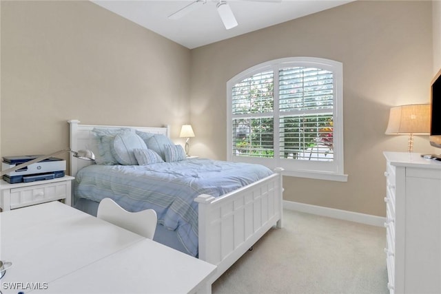 bedroom featuring a ceiling fan, light colored carpet, and baseboards