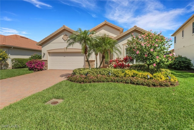 view of front of property with an attached garage, stucco siding, decorative driveway, and a front yard