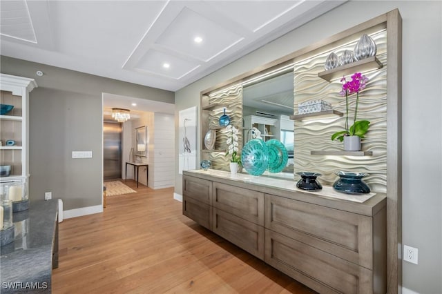 interior space featuring coffered ceiling, recessed lighting, baseboards, and light wood finished floors