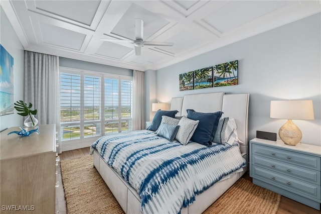 bedroom with ceiling fan, coffered ceiling, and wood finished floors