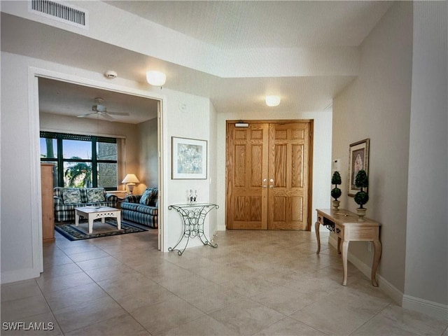 corridor with baseboards and visible vents