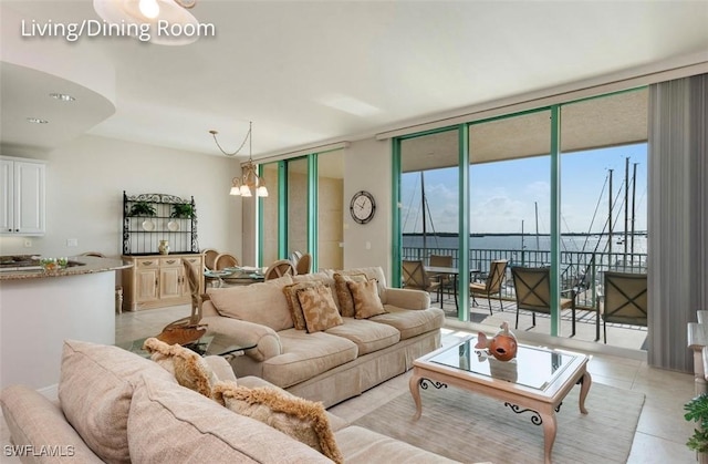 living room with expansive windows, light tile patterned floors, and an inviting chandelier