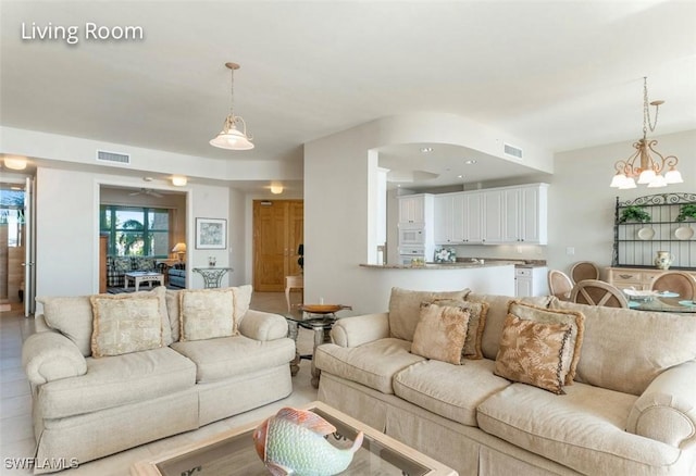 living area with an inviting chandelier and visible vents