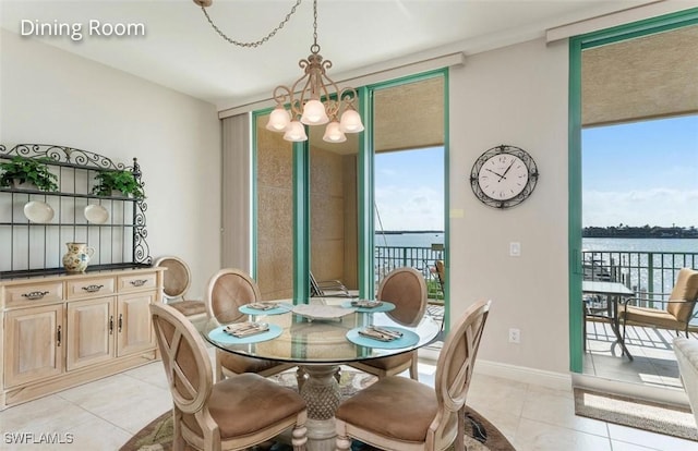 dining space with a chandelier, floor to ceiling windows, baseboards, and light tile patterned floors