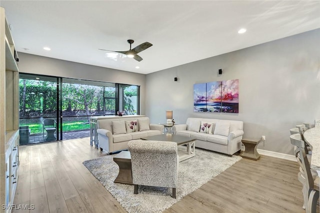 living room with recessed lighting, a ceiling fan, baseboards, and wood finished floors