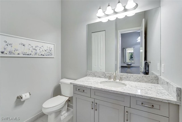 bathroom featuring toilet and vanity