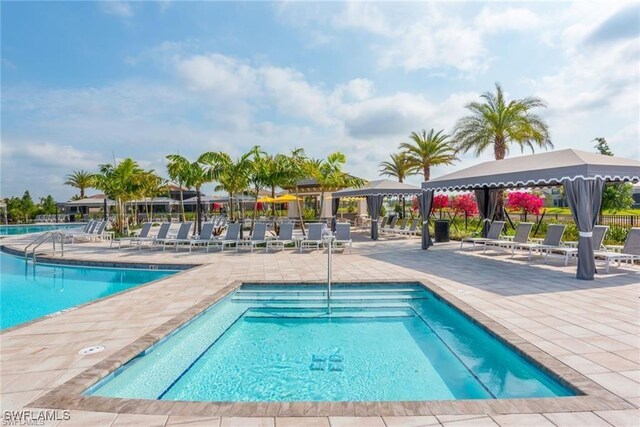 pool featuring a gazebo, fence, and a patio