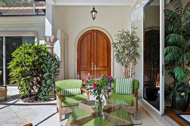 doorway to property featuring stucco siding