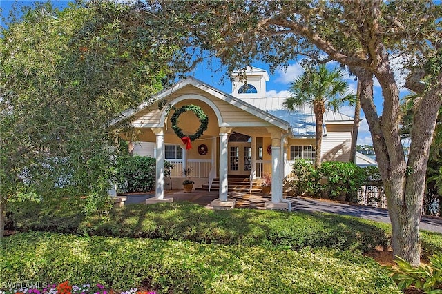 bungalow-style house with covered porch and french doors