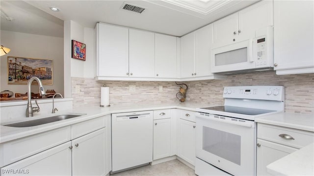 kitchen with white appliances, a sink, visible vents, white cabinetry, and light countertops