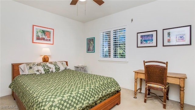 bedroom featuring ceiling fan, baseboards, and light colored carpet