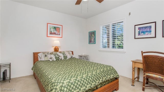 bedroom with light colored carpet, ceiling fan, and baseboards