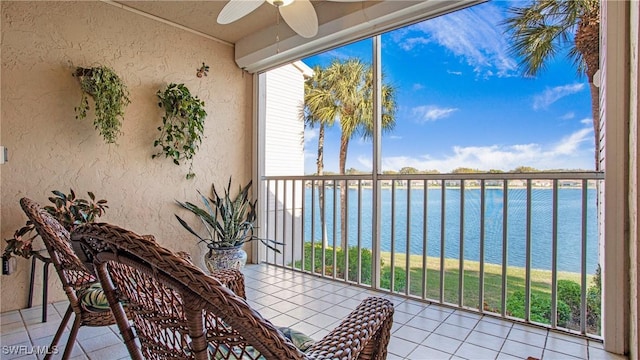 balcony with a water view and a ceiling fan