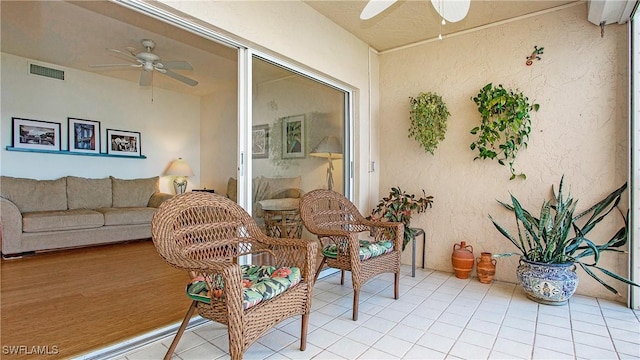 sunroom / solarium featuring ceiling fan and visible vents