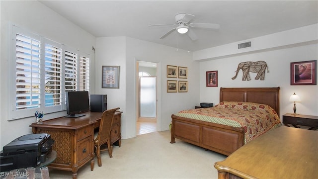 bedroom featuring visible vents, a ceiling fan, and light colored carpet