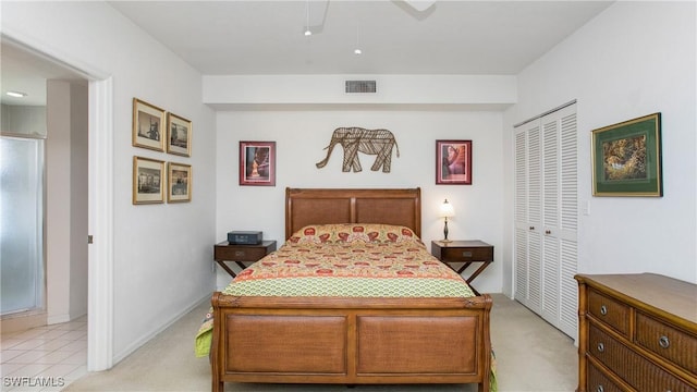 bedroom with a ceiling fan, light colored carpet, a closet, and visible vents