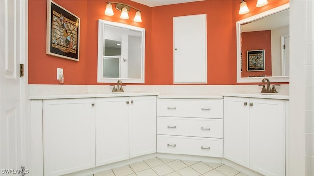 full bathroom with double vanity, tile patterned flooring, and a sink