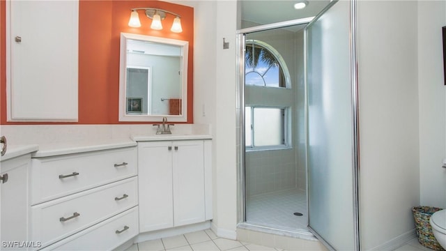 bathroom featuring a shower stall, vanity, and tile patterned floors