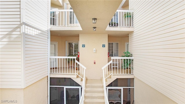 property entrance with stucco siding