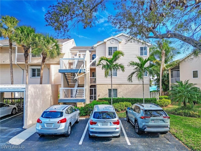 view of building exterior featuring uncovered parking