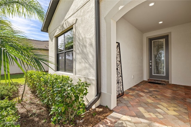 entrance to property with stucco siding