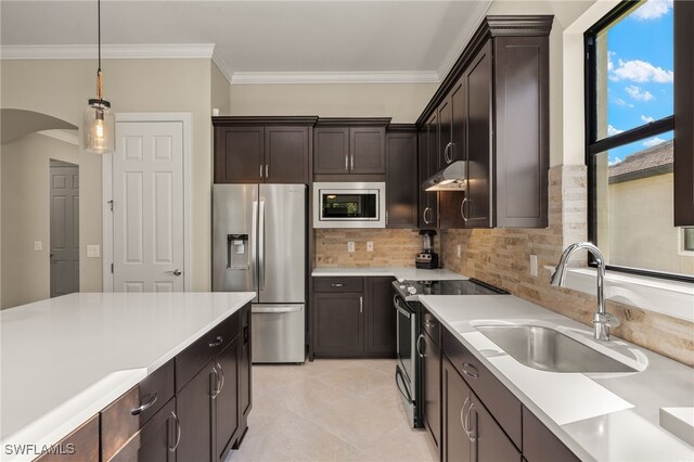 12108 Sussex St, Fort Myers, FL 33913 - kitchen with under cabinet range hood, appliances with stainless steel finishes, a sink, and light countertops