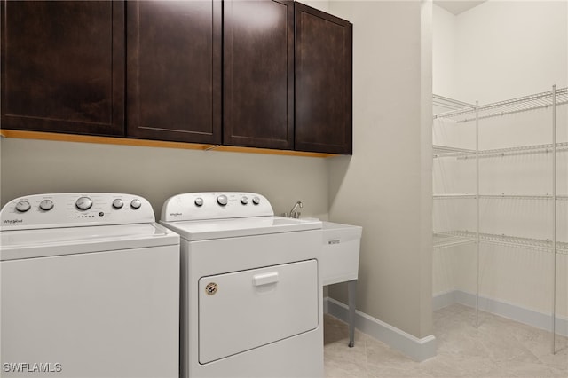 12108 Sussex St, Fort Myers, FL 33913 - washroom with cabinet space, washing machine and clothes dryer, and baseboards