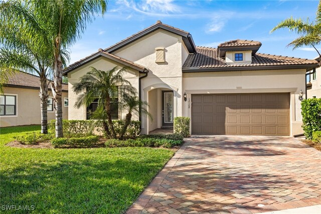 12108 Sussex St, Fort Myers, FL 33913 - mediterranean / spanish-style home featuring a tile roof, an attached garage, a front yard, stucco siding, and decorative driveway
