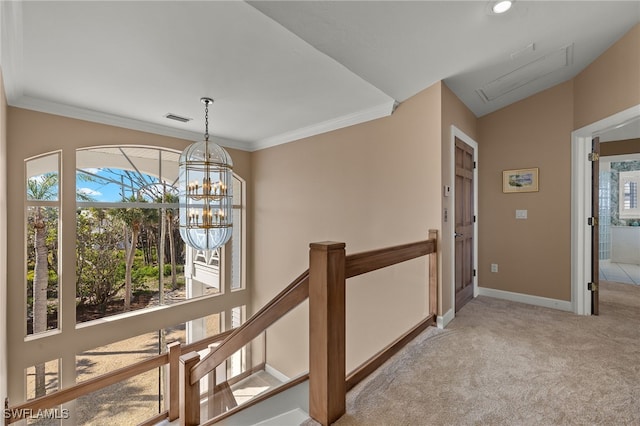 corridor featuring baseboards, visible vents, carpet flooring, an upstairs landing, and a notable chandelier