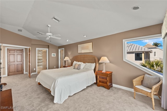 bedroom featuring light colored carpet, visible vents, vaulted ceiling, and baseboards