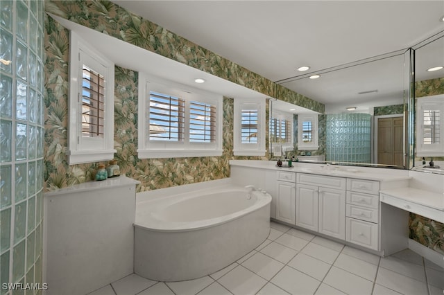 full bath featuring tile patterned flooring, a garden tub, vanity, and wallpapered walls