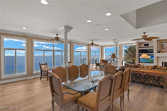 dining room with light wood-style flooring, decorative columns, and recessed lighting