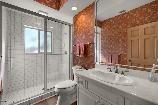 bathroom with a stall shower, visible vents, toilet, and wallpapered walls