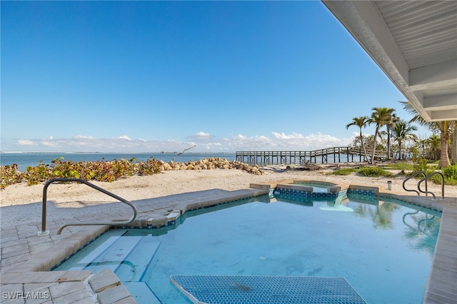 view of swimming pool featuring a pool with connected hot tub, a water view, and a patio