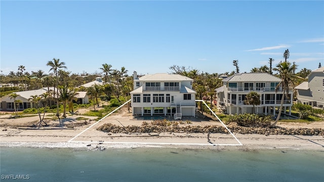 back of house featuring a water view and a balcony