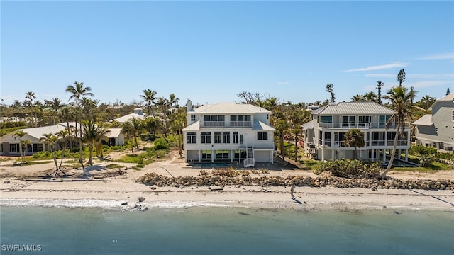 rear view of property with a water view and a balcony