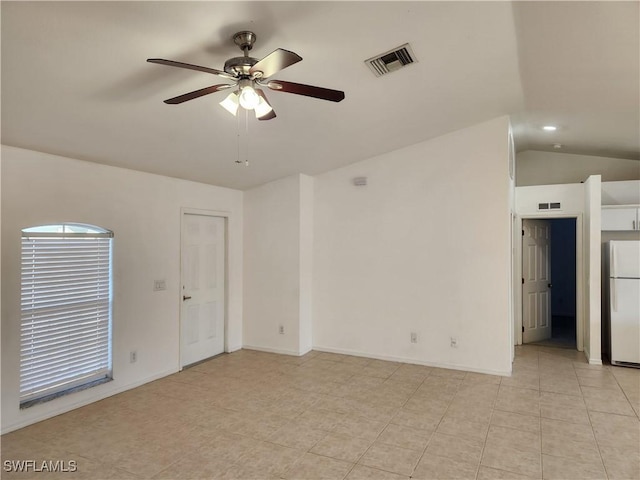 unfurnished room with a ceiling fan, lofted ceiling, visible vents, and baseboards